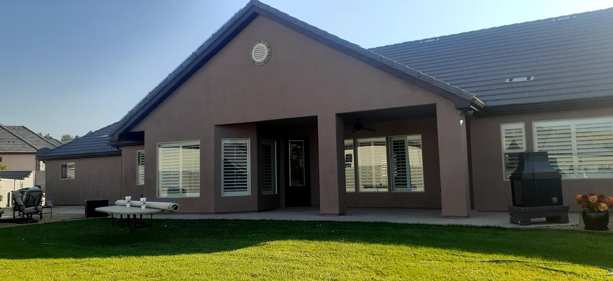 The rear elevation of a home finished in a deep mauve-brown